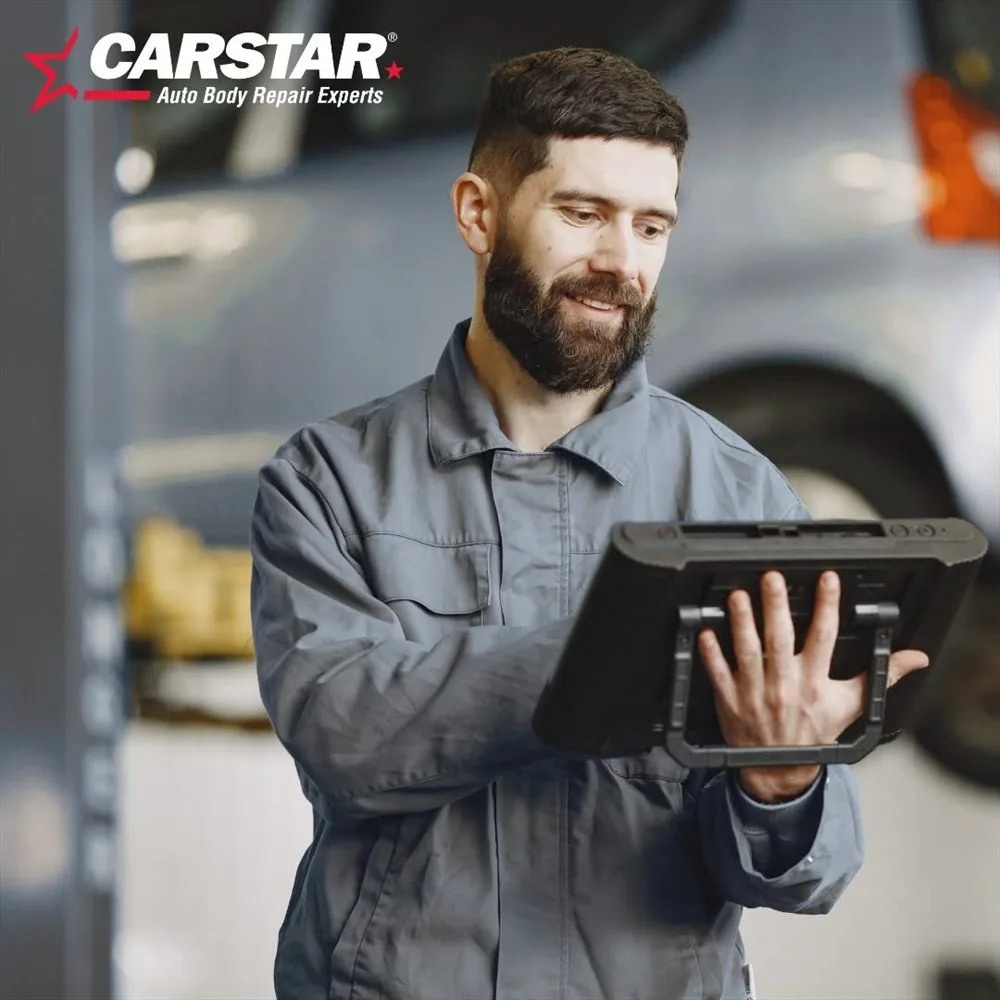 A technician reviewing a repair estimate on a tablet
